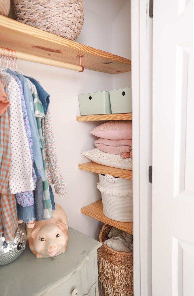 Shelf with clothing outlet bar