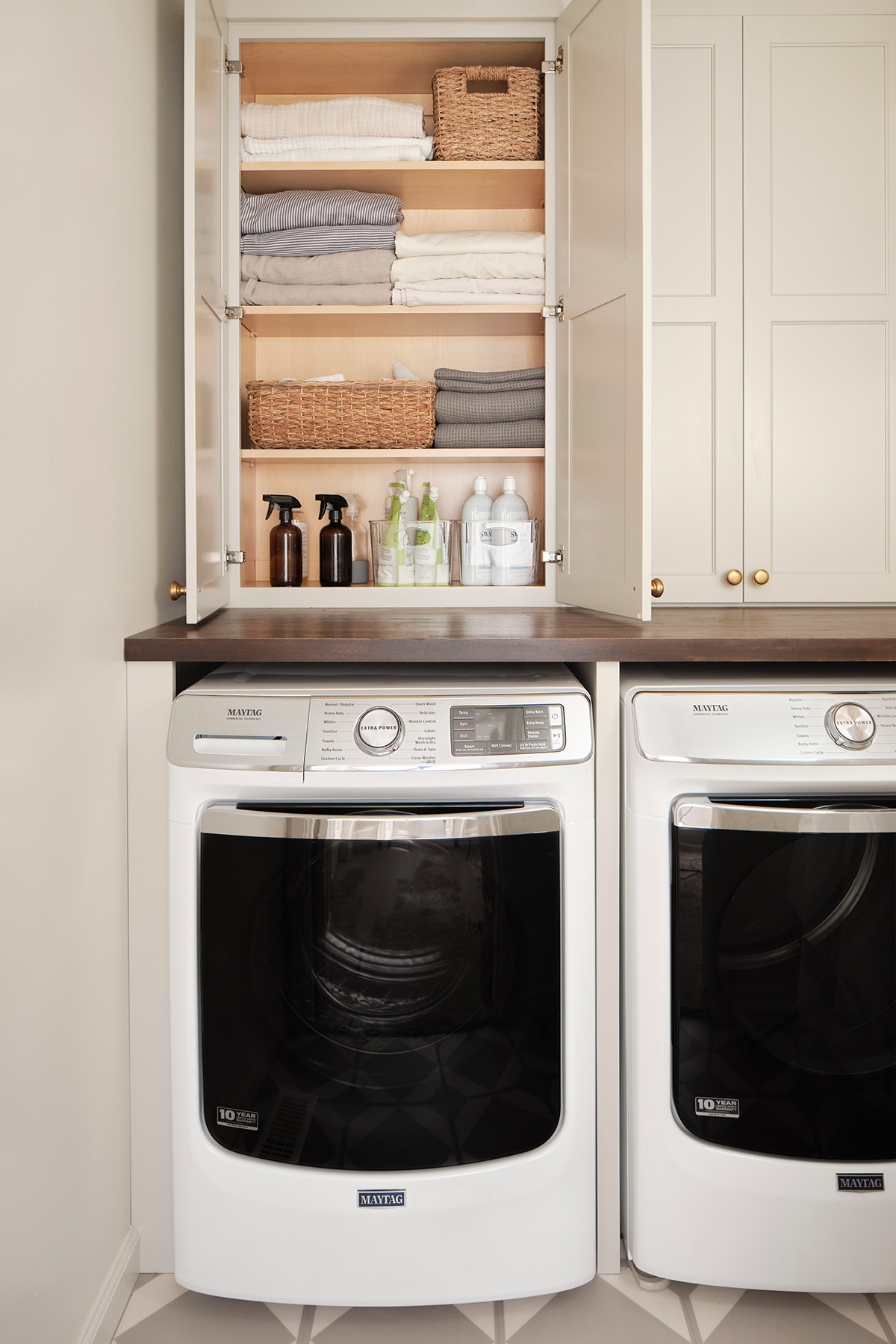 https://inhonorofdesign.com/wp-content/uploads/2023/03/laundry-room-cabinets-linen-closet-maytag-washer.jpg